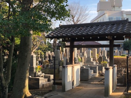 A large cemetery sits in front of the temple, on both sides of the entry path